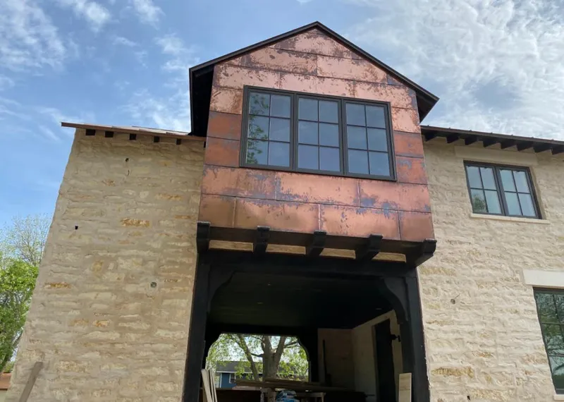 Copper metal panel facade on a stone building for Roof Repair in Bethel Park